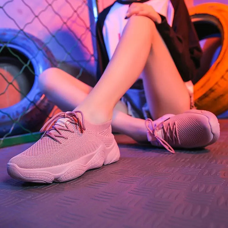 Women's white casual sports shoes with woven upper, thick rubber sole, and front strap fastening