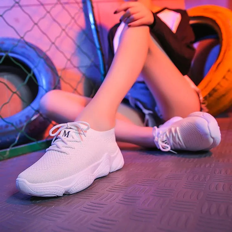 Women's white casual sports shoes with woven upper, thick rubber sole, and front strap fastening