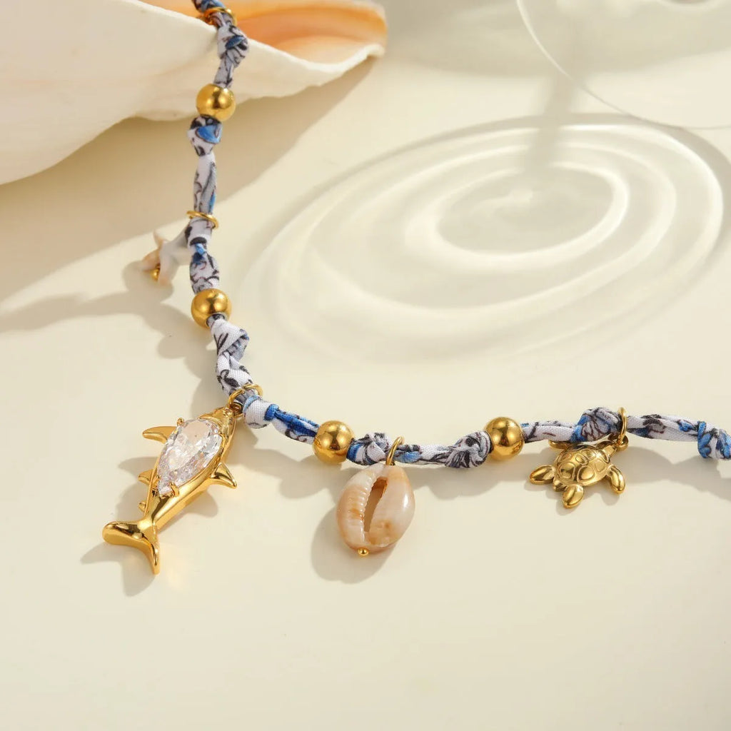 Gold starfish shell pendant on hand-knotted rope chain, 18K plated stainless steel, geometric shape