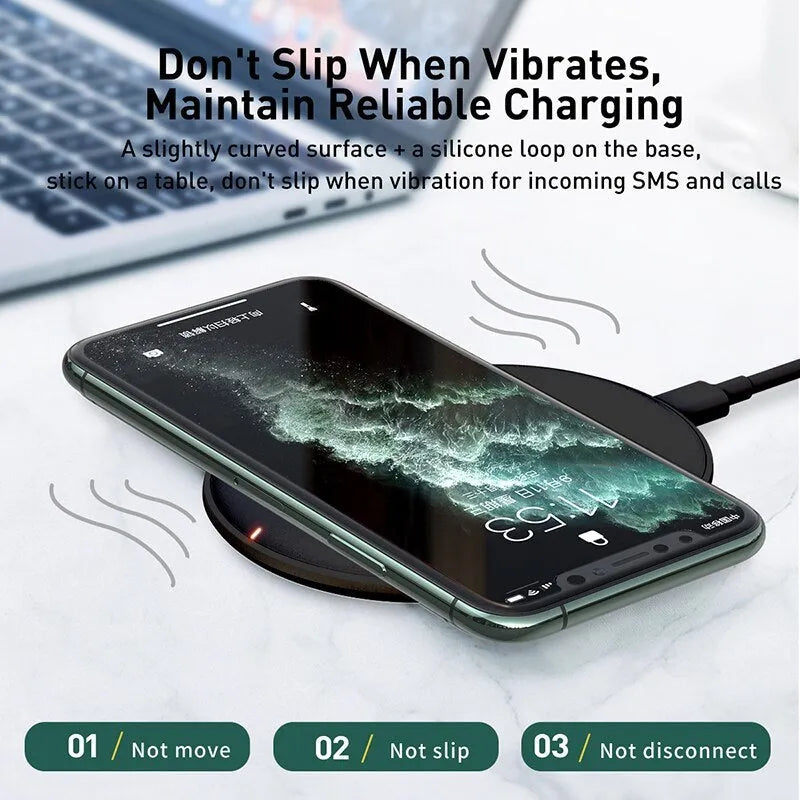 Black Baseus wireless charging pad with a textured surface and a small LED light, next to a mobile phone.