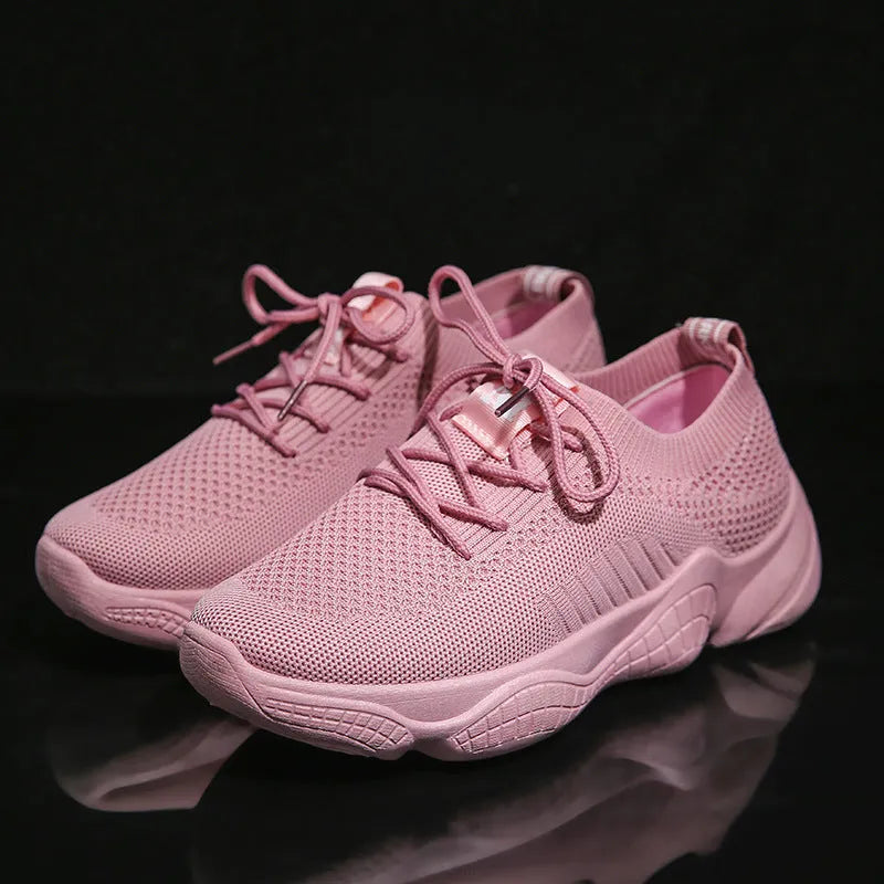 Women's white casual sports shoes with woven upper, thick rubber sole, and front strap fastening