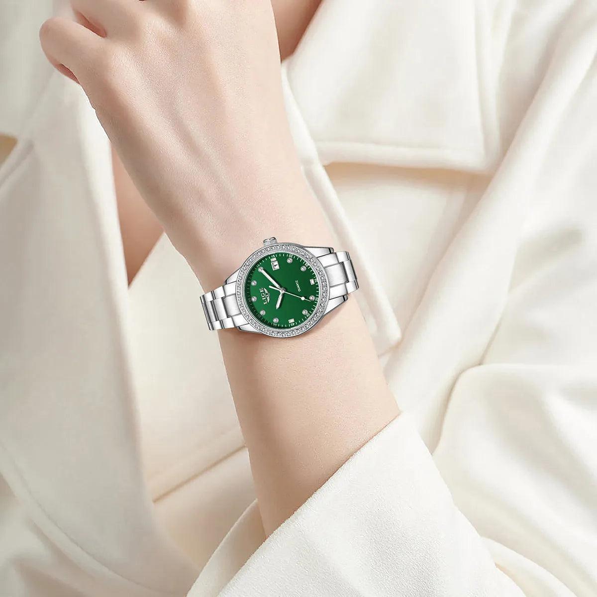 Silver stainless steel women's quartz watch with luminous hands on a 34mm round dial.