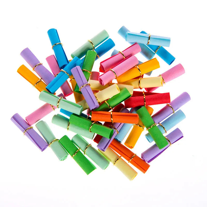 Assorted coloured mini paper scrolls for drift bottle messages with metal eyelets, shown in different sizes.