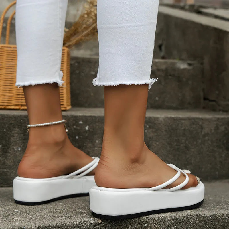 Thick bottom herringbone pattern flip-flops in multiple colours on a white background.