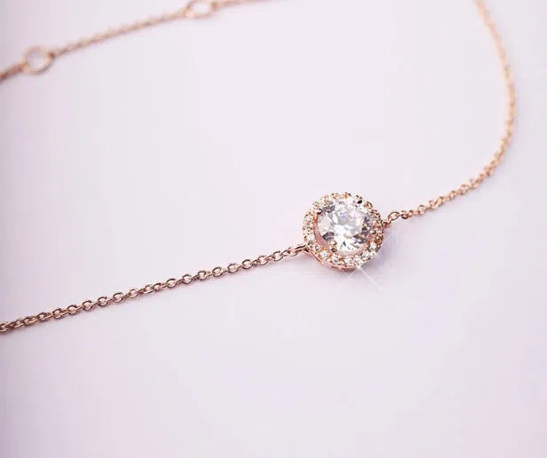 Round crystal anklet on ankle, rose gold tone with alloy and silver or gold plating, 22cm chain plus 4cm extender
