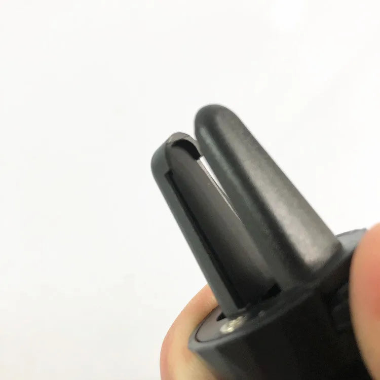 Black car phone holder mounted on vehicle air vent with smartphone