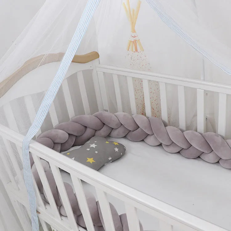 Braided knot style baby cot bumper in spandex crystal velvet fabric, shown in a light grey colour.