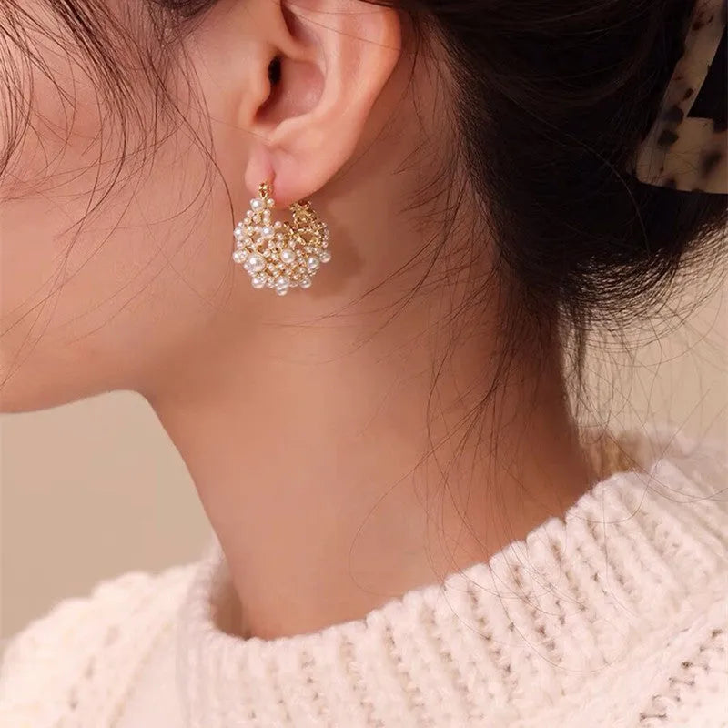Gold colour women's floral basket design earrings with small beads and pearl inlay on copper