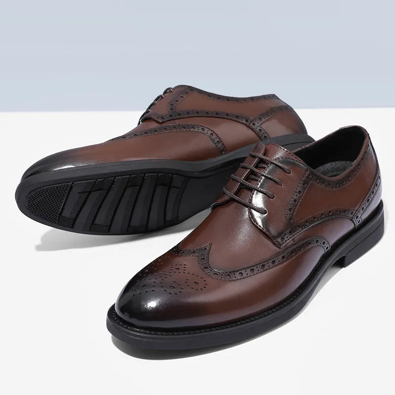 Men's black and brown brogue leather shoes for business style on a plain background.