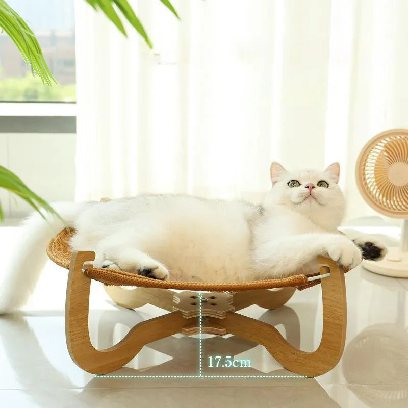 Brown woven rattan square pet bed basket for cats and small dogs on a wooden floor.