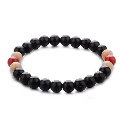 Natural stone beaded bracelet with lava stones for essential oils on a wrist.