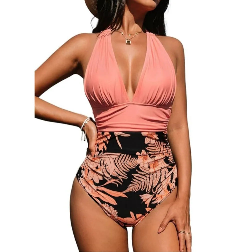 Women's halter neck one-piece swimsuit in floral pattern on a mannequin.