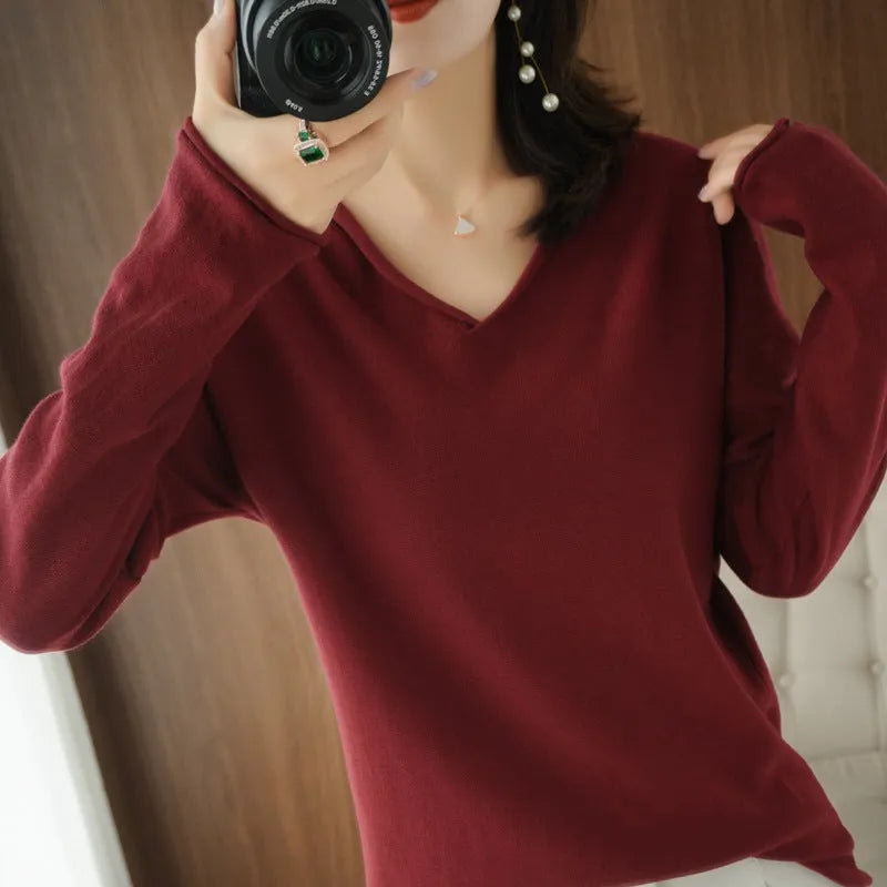 Women's V-neck long sleeve knit pullover top in a macaron colour on a hanger.