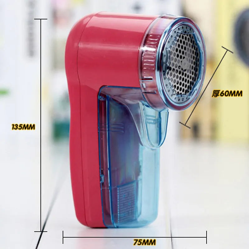 Portable electric clothing lint remover device on a sweater.