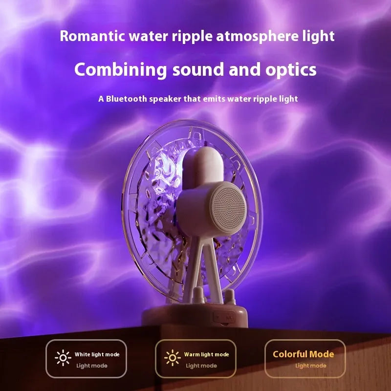 Pink Ferris wheel Bluetooth speaker projecting colourful water ripple light patterns on a surface.