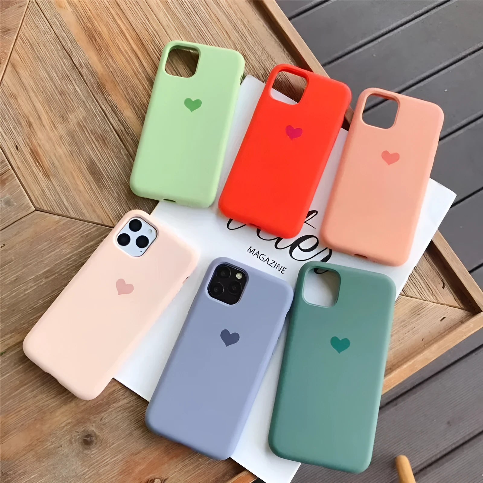 Solid colour silicone phone case for iPhone models showing dark green, light pink and purple options