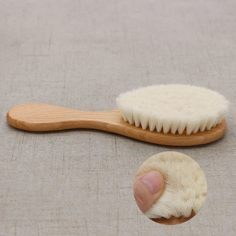 Beech wood baby shampoo brush with goat wool bristles in primary colour finish.