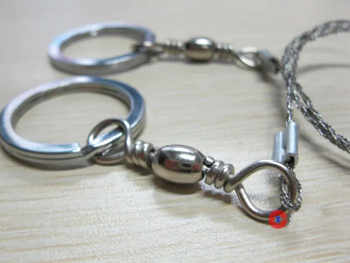 Stainless steel wire survival saw with thumb rings coiled for outdoor camping