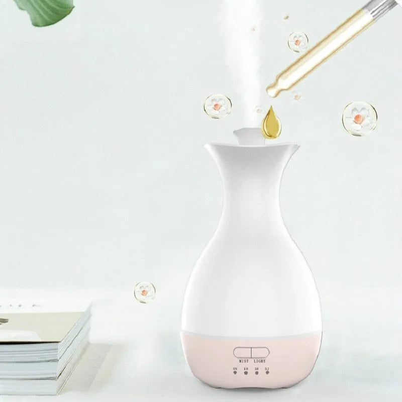 White or pink ultrasonic aroma diffuser vase with colourful LED night light and water tank.