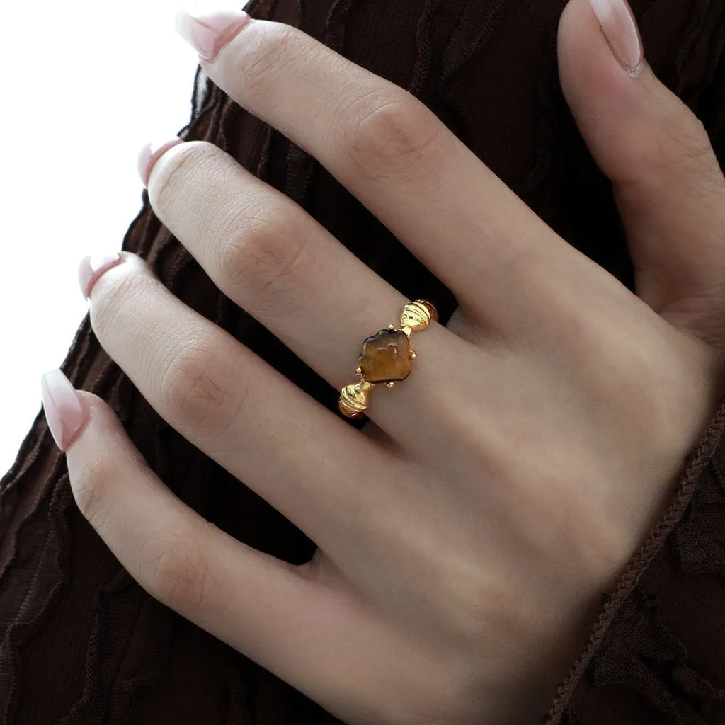 Women's adjustable silver ring with a shell tiger eye design in a gold tone finish.