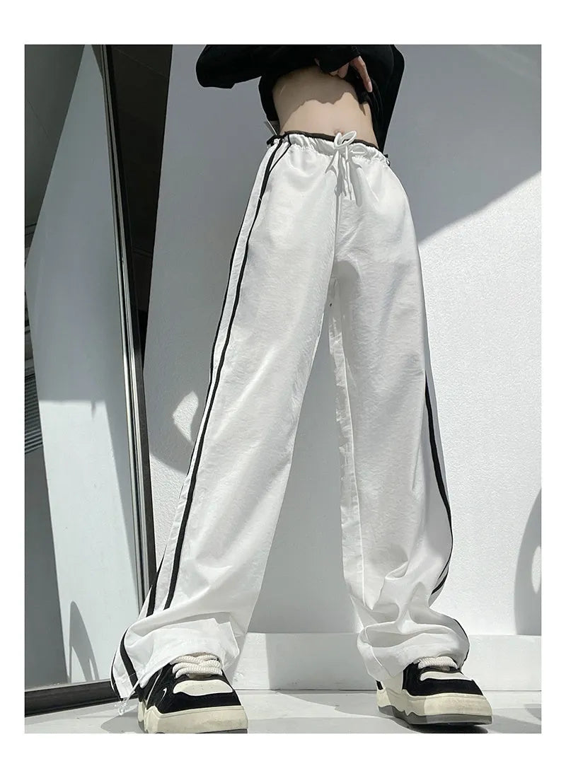 Women's loose straight-leg trousers with contrast ribbon detail in navy blue.