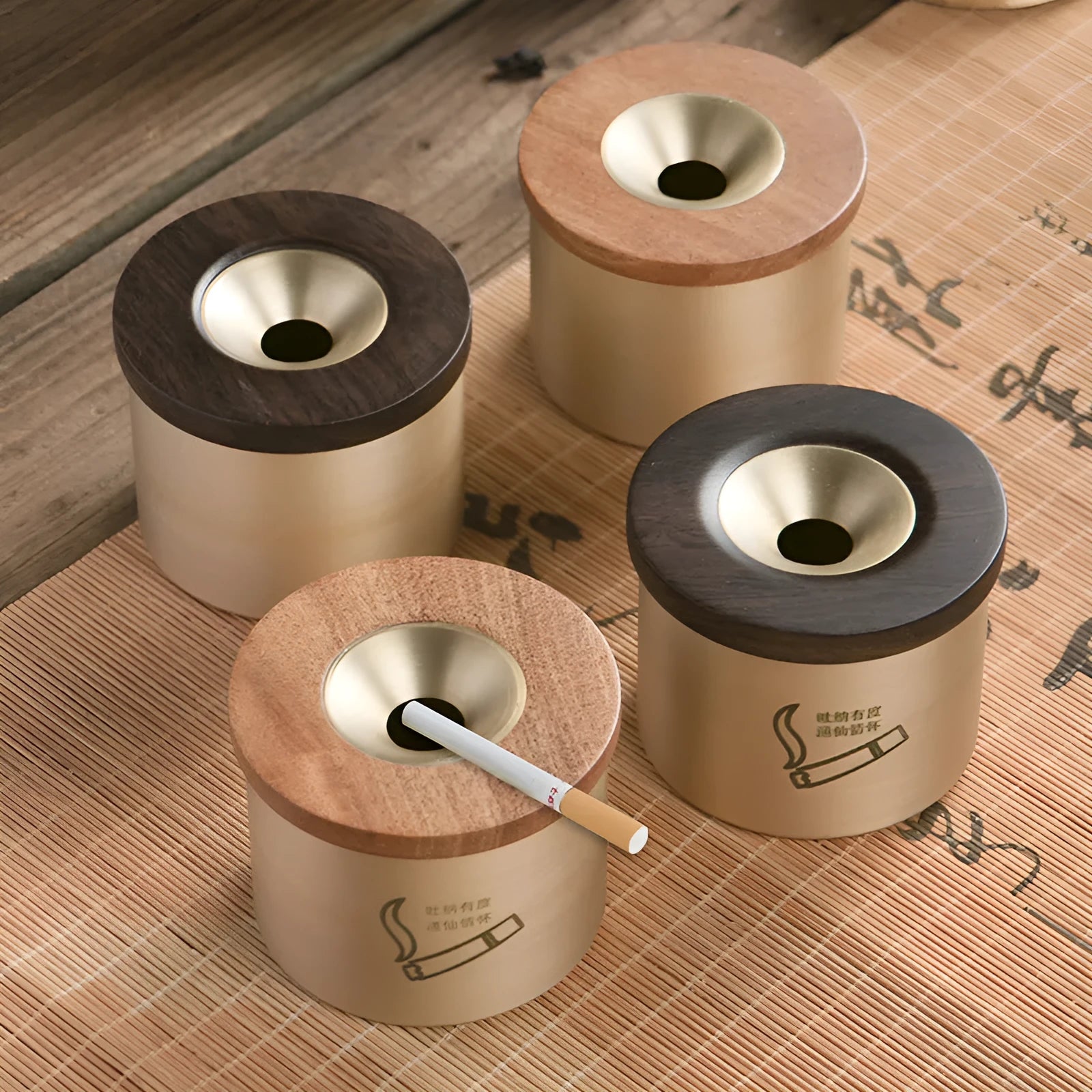 Brass ashtray with wooden lid in blackwood or rosewood finish, 6 cm diameter, on a table.
