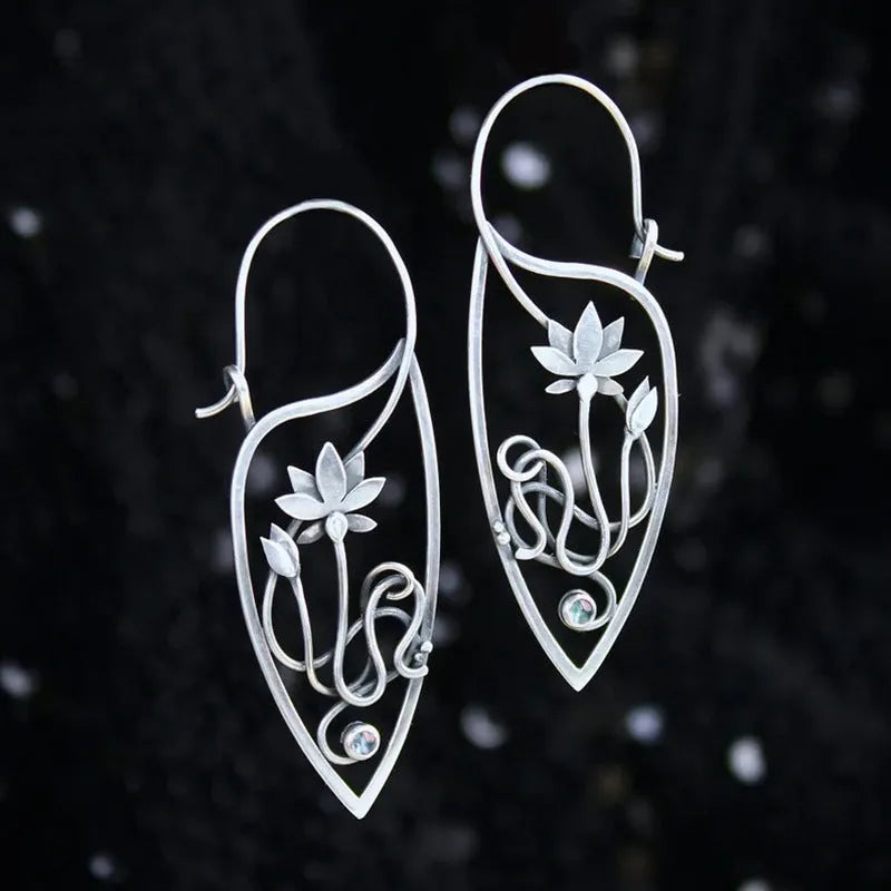 Silver rhinestone earrings with geometric lotus vine design on alloy base