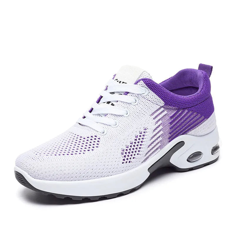 Women's pink flyknit running shoes with lace-up front, mesh lining, and flat PVC sole on a striped background.