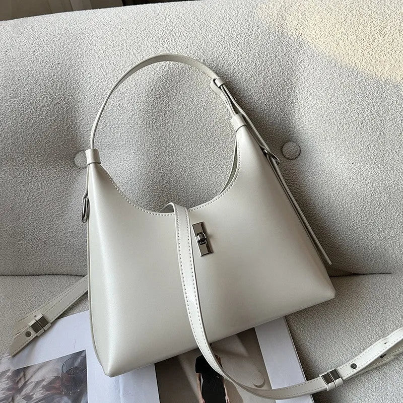 Soft genuine leather crossbody shoulder bag in a dumpling shape, shown in one of six available colours.