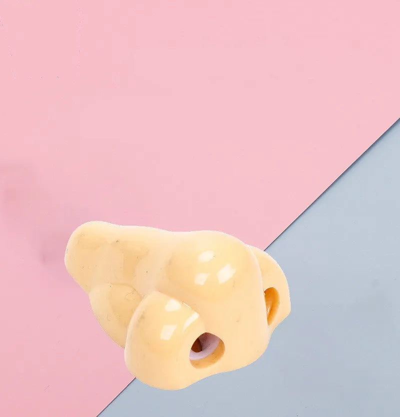 Flesh colour plastic pencil sharpener showing geometry shape and big nostril opening