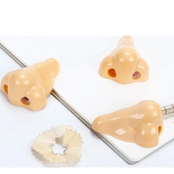 Flesh colour plastic pencil sharpener showing geometry shape and big nostril opening