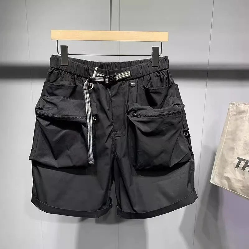 Men's solid black loose-fit work shorts with pockets, shown above the knee.