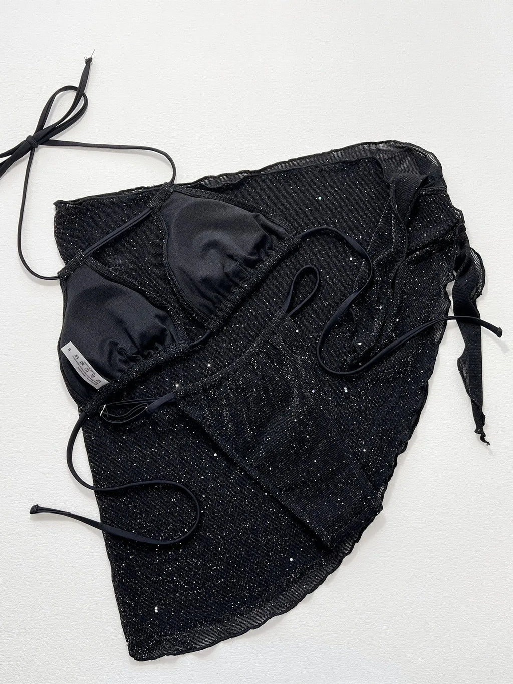 Black three-piece bikini swimsuit set with sports bra top and matching shorts