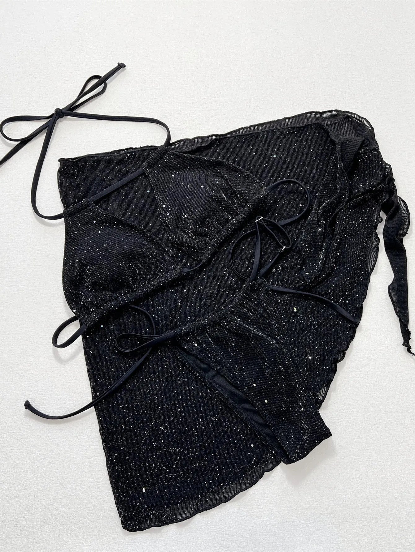 Black three-piece bikini swimsuit set with sports bra top and matching shorts