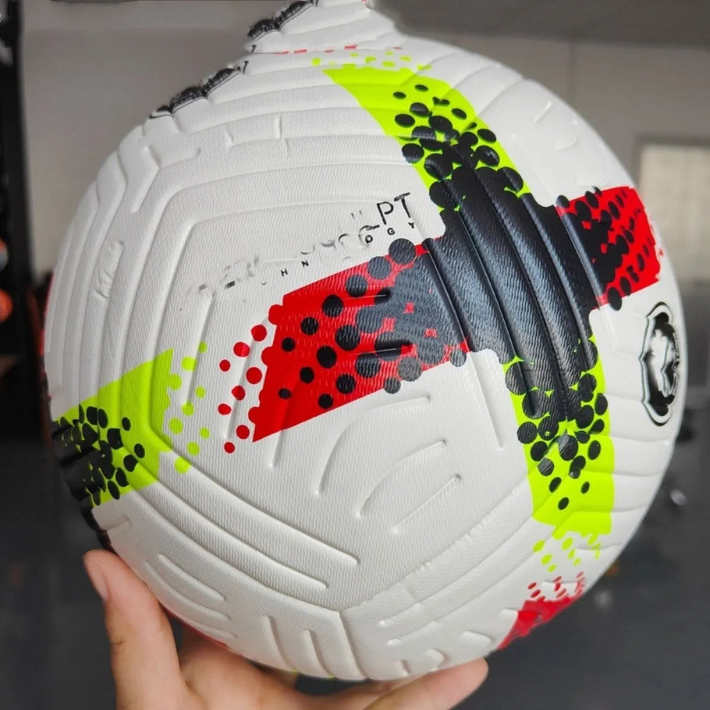 Fluorescent green size 5 PU football with seamless thermal adhesive construction on a pitch.