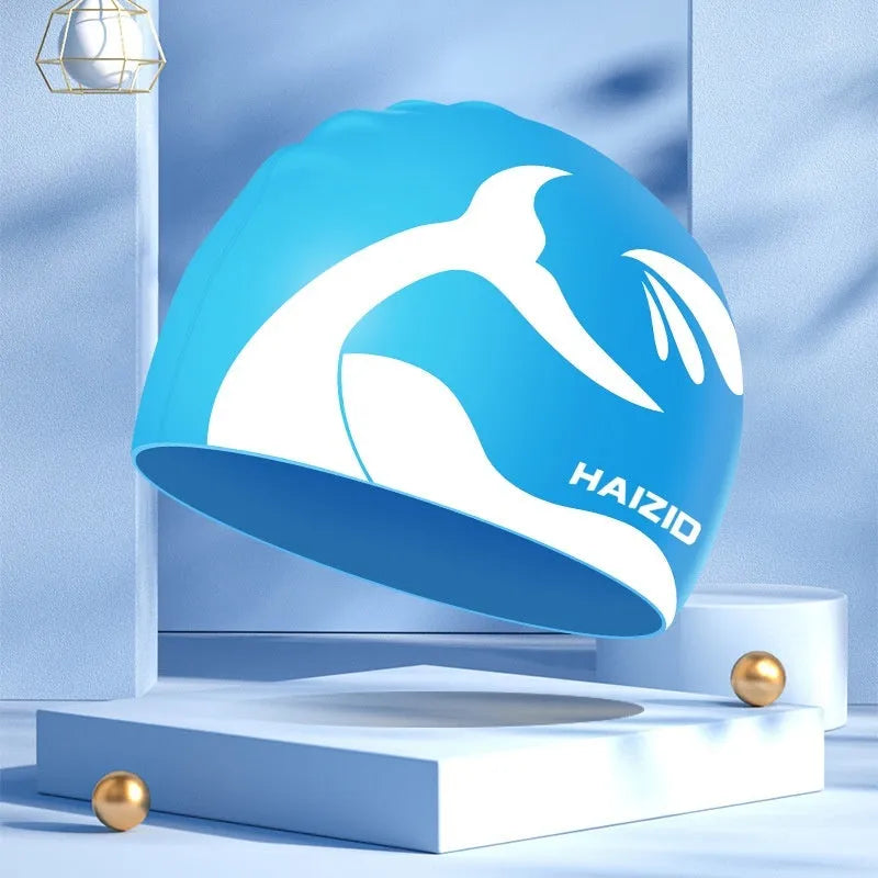 Silicone swim cap with whale tail pattern and waterproof ear protectors in four colour options.
