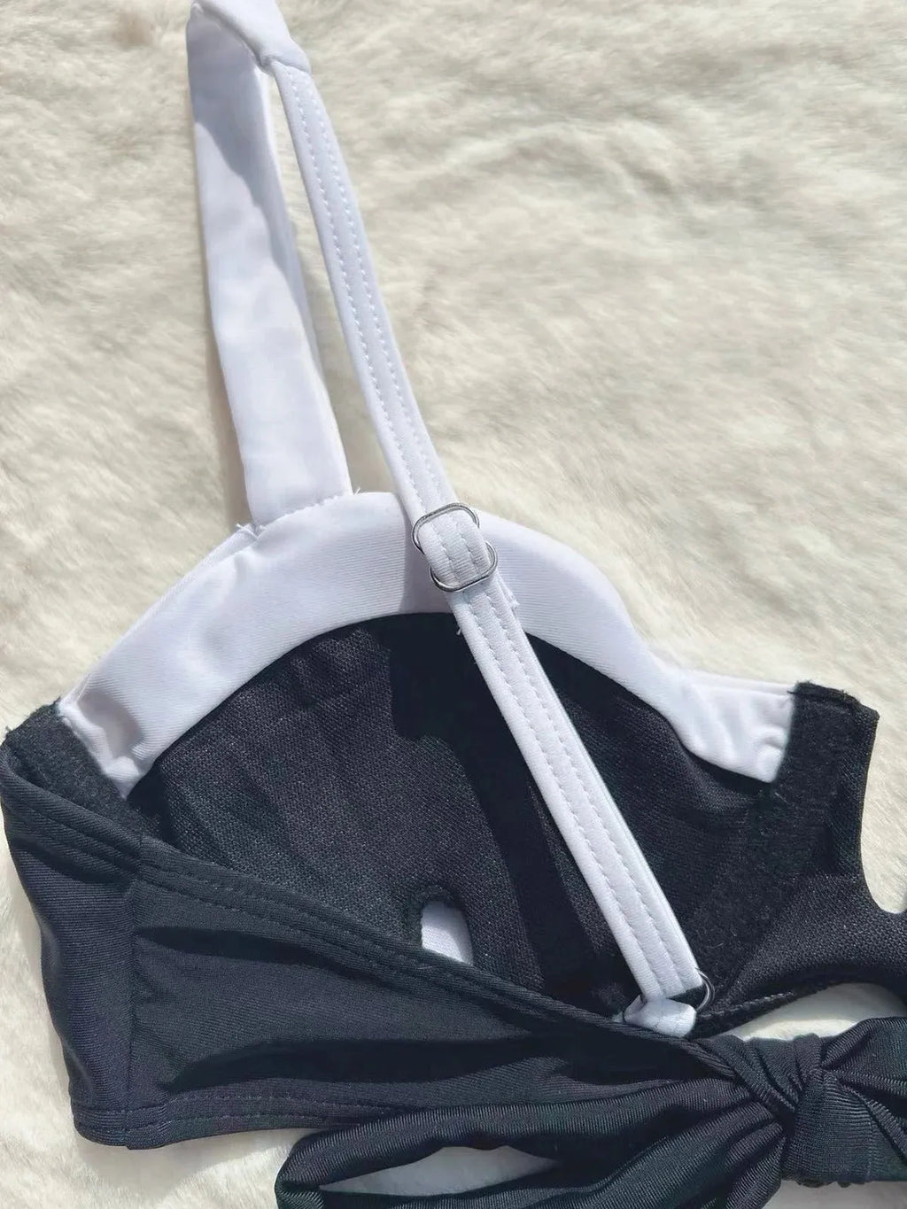 Women's low waist black bikini swimsuit with stitching split detail and briefs style.