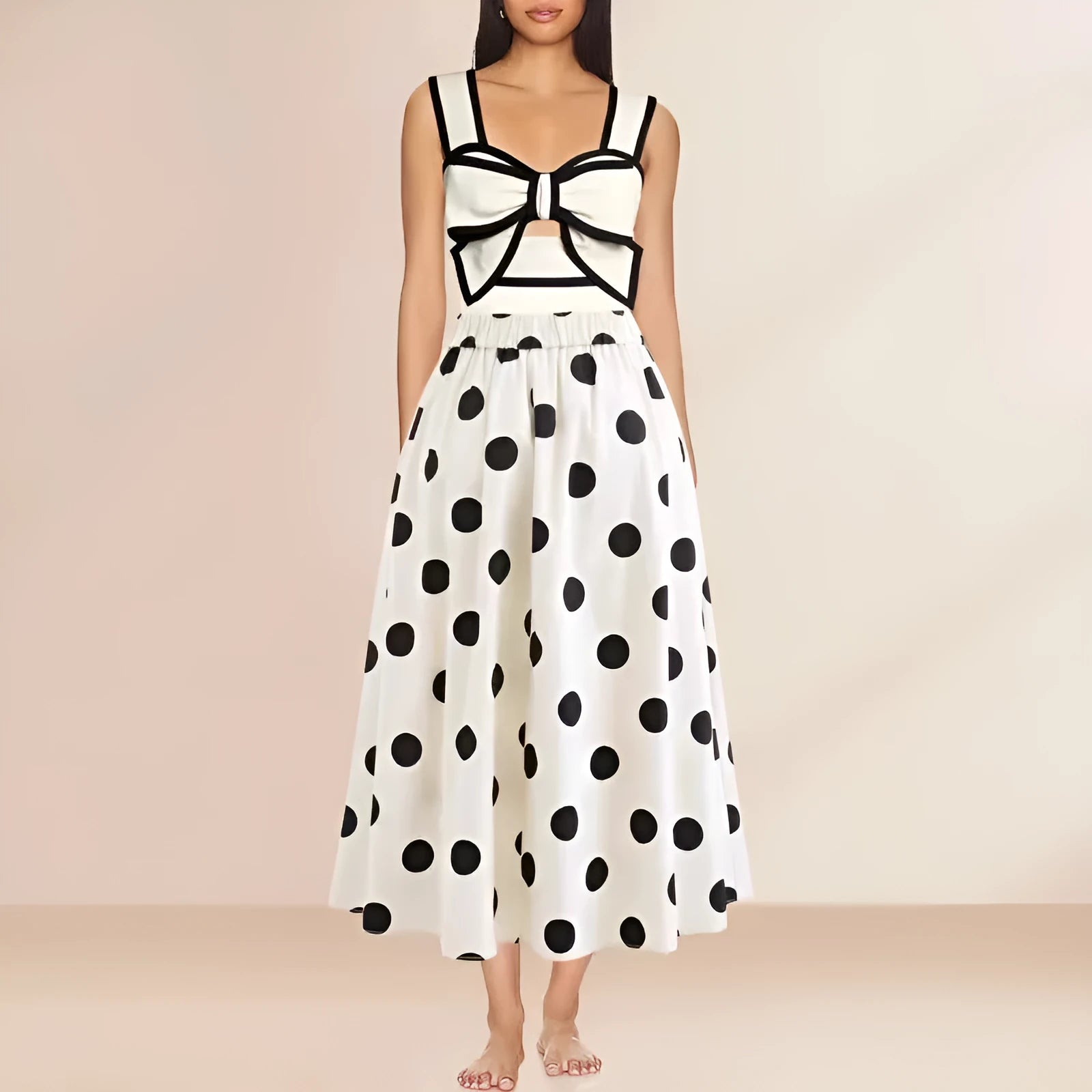 Women's black one-piece swimsuit with a white flared skirt and a bow detail.