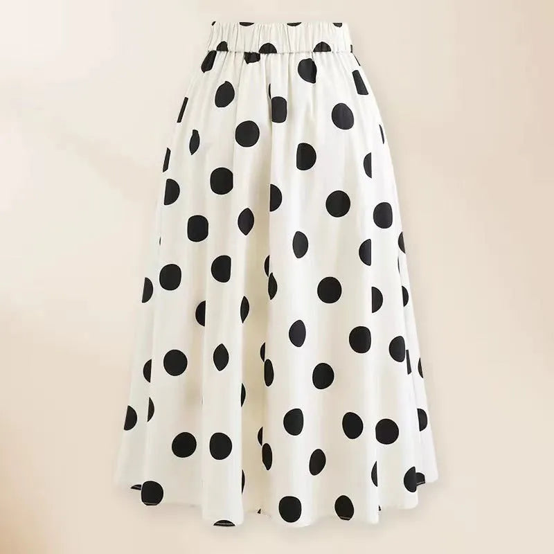Women's black one-piece swimsuit with a white flared skirt and a bow detail.