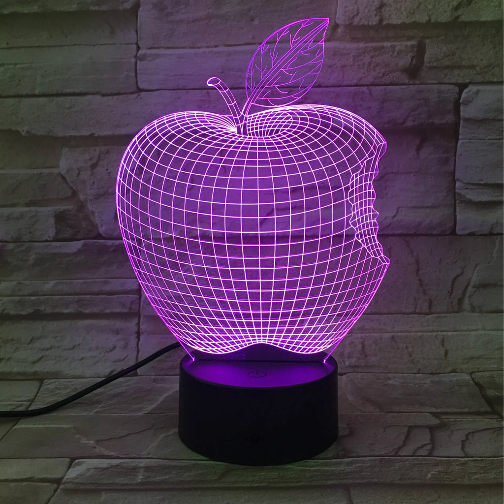 Colourful 3D fruit shaped acrylic LED night light with touch control on a table.