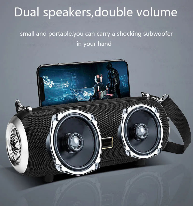 F666 portable fabric Bluetooth speaker with shoulder strap on a table next to a phone
