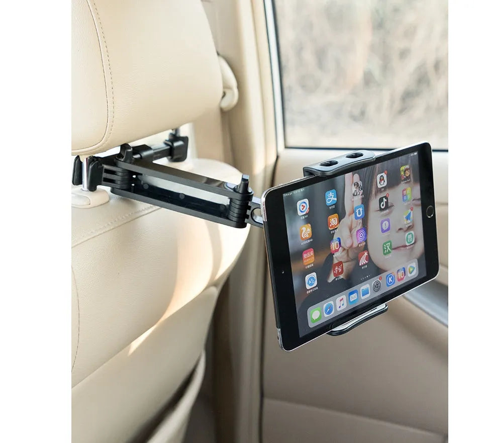 Black universal car phone holder mounted on vehicle rear seat with tablet in snap-in mechanism