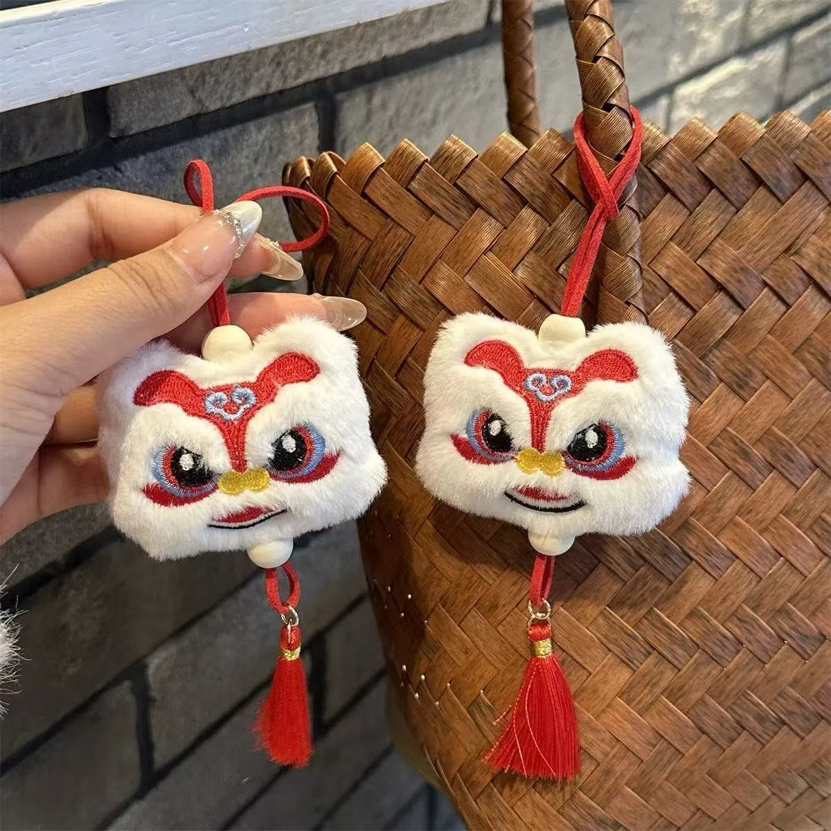 Chinese style plush lion keychain ornament with cartoon design and star stone details on blue background