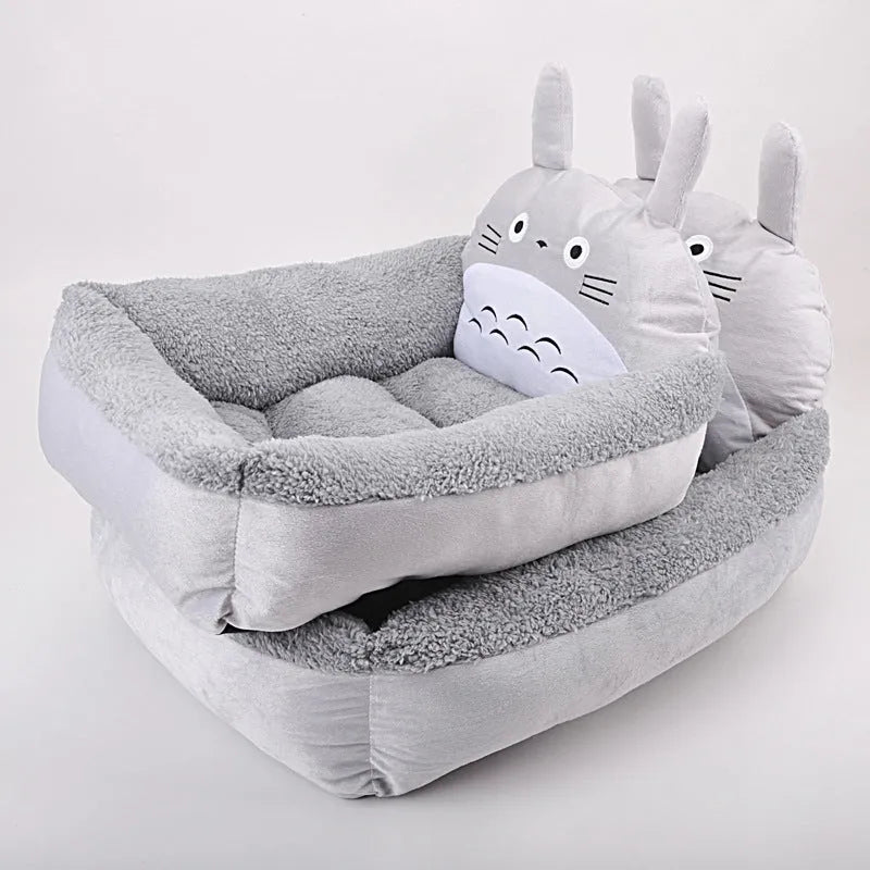 Cartoon-style plush pet sofa bed with a raised rim for a small dog or cat, shown in a blue colour