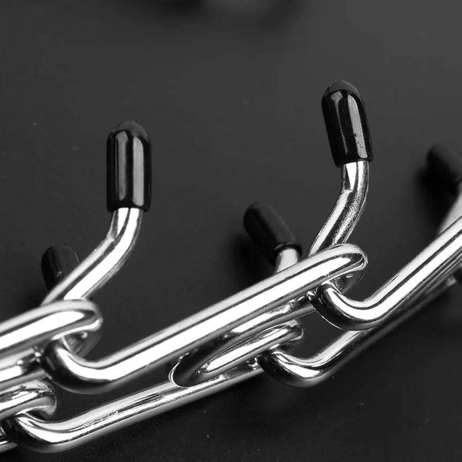 Stainless steel dog pinch training collar with round links and black rubber tips, shown on a size chart.