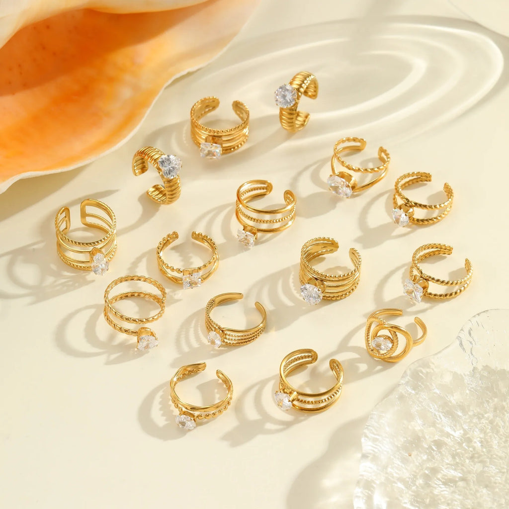Gold-toned stainless steel ring with zircon details in a geometric heart shape design on a finger.