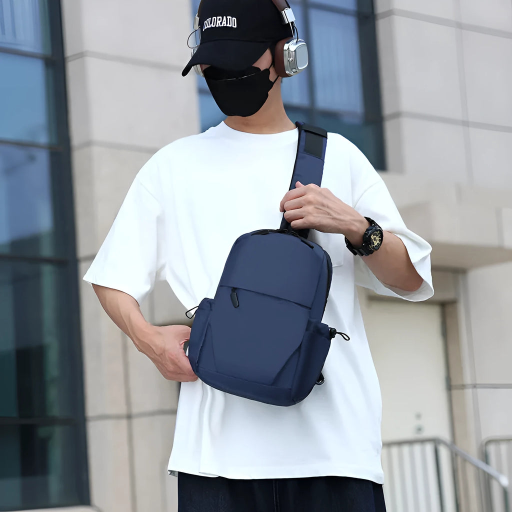 Grey men's waterproof chest bag shown on shoulder, displaying its 33cm height and spacious main compartment.