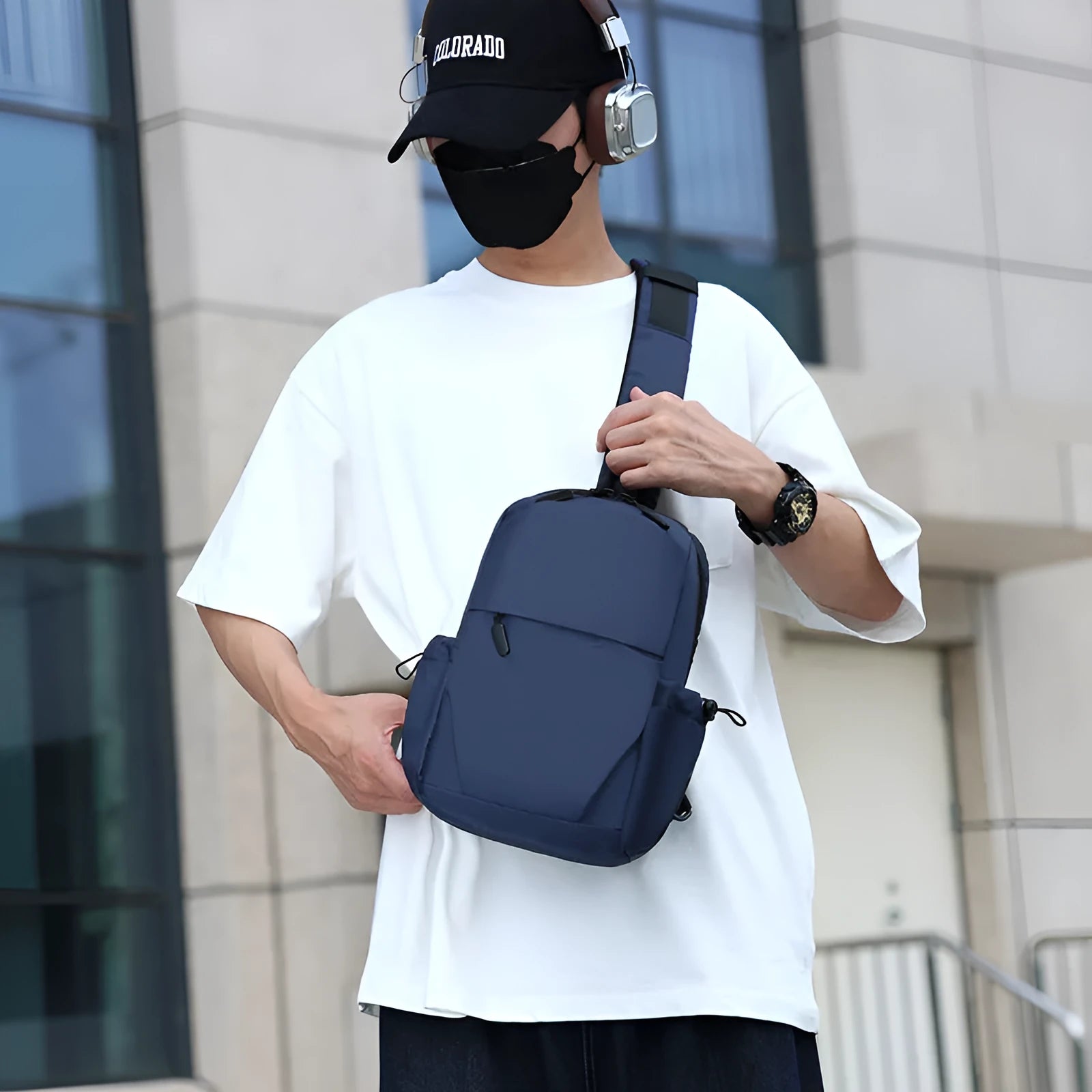 Grey men's waterproof chest bag shown on shoulder, displaying its 33cm height and spacious main compartment.