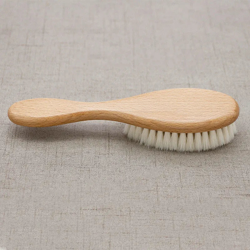 Beech wood baby shampoo brush with goat wool bristles in primary colour finish.