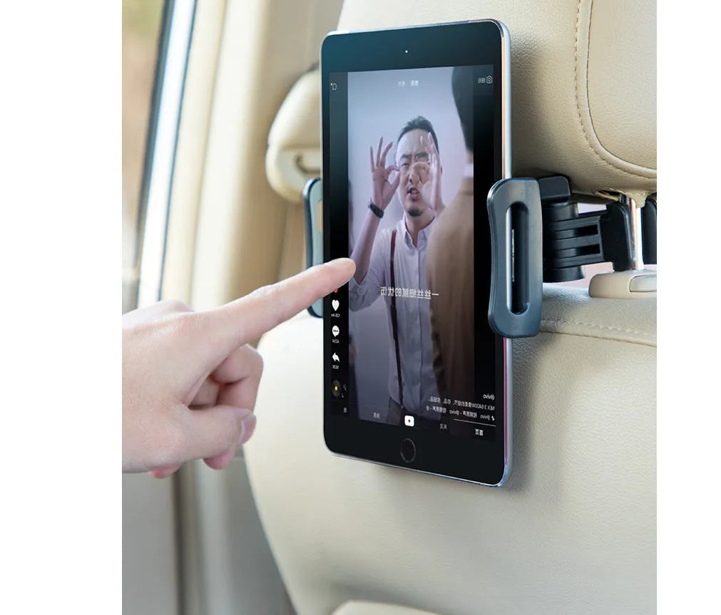 Black universal car phone holder mounted on vehicle rear seat with tablet in snap-in mechanism
